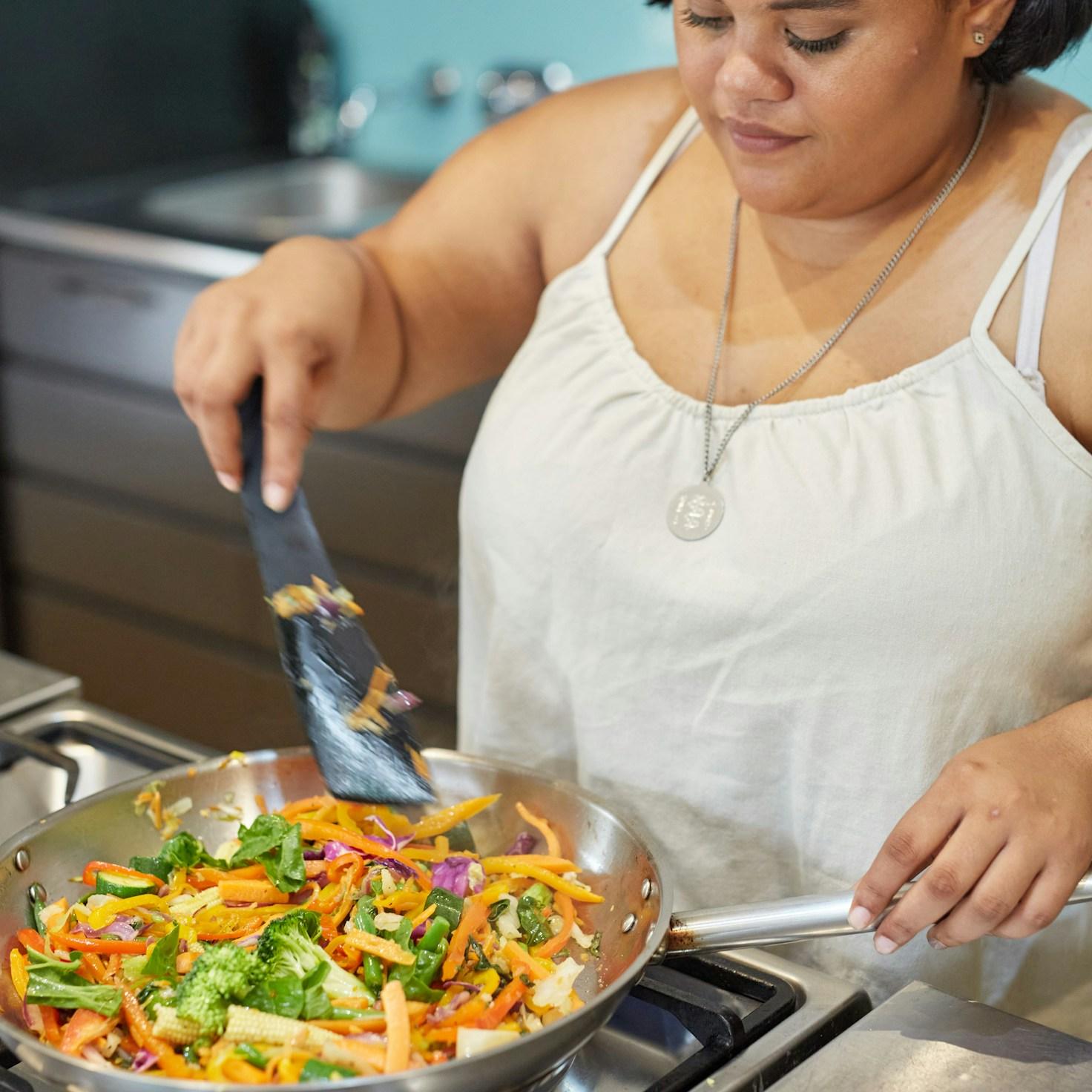People collaborating in a modern kitchen, sharing recipes and techniques